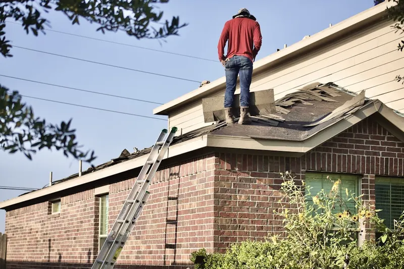 Professional roofer working on a residential roof in Fairlane